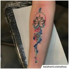 a woman's arm with a tattoo on it and a flower in the center