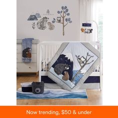 a baby crib with an animal themed bedding set