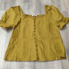 Brand New With Tags Mustard Yellow Madewell Blouse Beautiful Detail In The Sleeves With Buttons All Across The Front Beautiful Elastic Back For Comfortable Wear Size: Oo Brand: Madewell Gold Fitted Casual Blouse, Casual Mustard Cotton Blouse, Mustard Short Sleeve Casual Blouse, Mustard Casual Short Sleeve Blouse, Casual Mustard Short Sleeve Blouse, Gold Fitted Top For Day Out, Fitted Gold Top For Day Out, Casual Gold Blouse For Spring, Mustard Short Sleeve Blouse For Summer