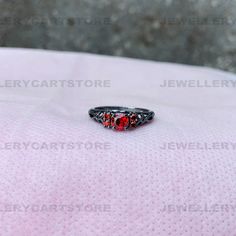 -------------------S p e c i f i c a t i o n s------------------- D e t a i l s : Center Stone: 5.00mm Center Stone Weight: 0.50 Ct. (Approx) Center Stone: Shape: Round Shape Center Stone Color: Red Center Stone: Lab Created Metal type: 925 Sterling Silver Nickel-Free Rhodium Plated Stamp: 925SIL Ring Size Available: 3 US to 14 US (All Middle Size Available) Service:- Free Engraving Upon Request This beautiful ring is made with the highest quality simulated center and side stones --------------- Pear Cut Diamond Ring, Red Garnet Ring, Garnet Gem, White Gold Solitaire, Gold Solitaire Ring, Three Stone Ring, Black Ring, Garnet Ring, Style Punk