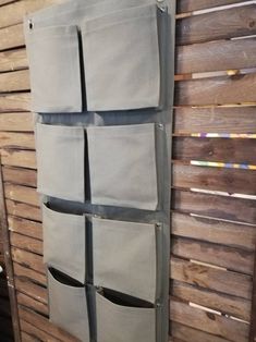 a wooden wall with several pockets on it