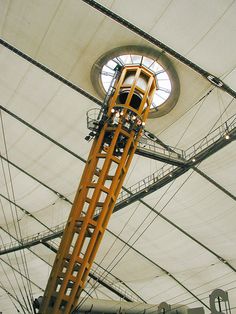 the inside of a large white tent with a clock on it's side and wires running underneath