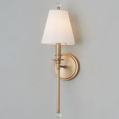 a wall light with a white shade on it