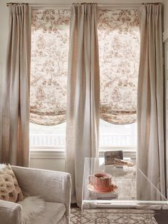 a living room filled with furniture and curtains