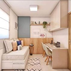 a small room with a couch, desk and shelves in the corner next to it