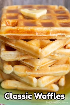 a stack of waffles sitting on top of a green plate