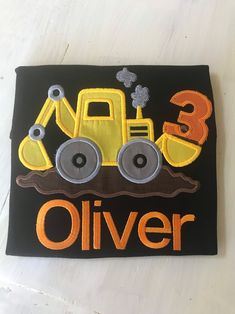 an embroidered patch with a tractor on it that says 3, 3, and 3