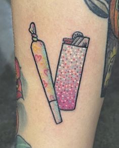 a woman's leg with a lighter tattoo on it