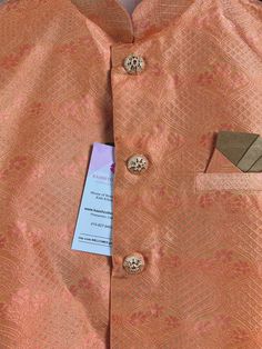 Premium quality Silk Men's Waist Coat in Peachy Pink Color with Floral Design Floral designs. Please note - there are small zari weaving that sparkles a bit. Please check the video carefully to understand the jacket well before purchase. Can be paired with a Kurta Pajama Set. Item : Men's JacketReady to Wear : YesJacket Color : Peach Fabric : Raw SilkWork : Fancy buttons, Self Deign Pattern Material Pattern : DesignerLining : Yes Measurements of the Jacket Size - 36Chest : 38 inches Length : 27 Traditional Nehru Jacket For Groom During Festivals, Traditional Nehru Jacket For Groom At Festivals, Festive Nehru Jacket With Pallu For Groom, Traditional Gold Nehru Jacket For Groom, Festive Nehru Jacket With Stand Collar For Wedding, Gold Nehru Jacket For Groom, Festive Occasion, Transitional Wedding Nehru Jacket With Stand Collar, Long Sleeve Nehru Jacket For Groom, Long Sleeve Nehru Jacket For Grooms And Festivals