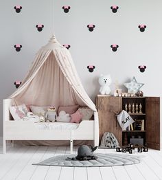 a child's bedroom with pink hearts on the wall