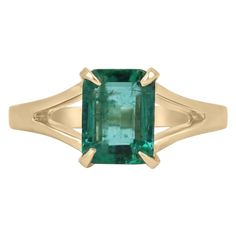 Enthrall in this stunning solitaire natural emerald ring. The gemstone showcases a fine quality Zambian emerald cut emerald with superb qualities such as excellent luster and transparency, as some of many. Set in a 14K yellow gold solitaire, four-prong setting, with a split shank and satin gold finish. Setting Style: Prong Setting Material: 14K Yellow Gold Setting Weight: 3.5 Grams Main Stone: Emerald Shape: Emerald Cut Weight: 1.36-Carats Clarity: Transparent Color: Deep Vivid Green Luster: Exc Gold And Emerald Ring, Brushed Gold Ring, Emerald Solitaire Ring, Emerald Cut Solitaire, Gold Emerald Ring, Colombian Emerald Ring, Natural Emerald Rings, Emerald Ring Gold, Yellow Gold Solitaire