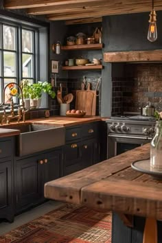 a kitchen with black cabinets and wooden counter tops, an island in the middle is surrounded by potted plants