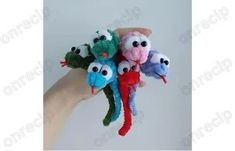 a hand holding a bunch of stuffed animals in it's left hand with eyes on them