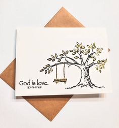 a card with the words god is love written on it and a swing hanging from a tree