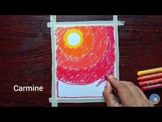 someone is drawing with colored crayons on paper