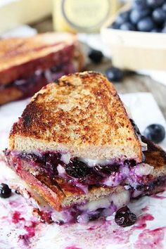 a grilled cheese and blueberry sandwich on parchment paper