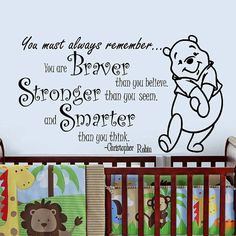 a baby crib with a teddy bear and quote on it