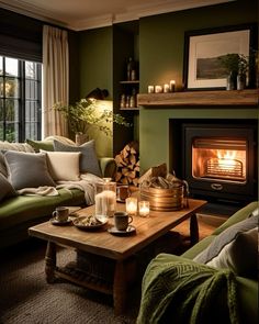 a living room filled with furniture and a fire place next to a window covered in candles