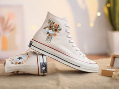 "The embroidered Converse High Top for weddings is inspired by the gorgeous bridal bouquet. With many years of experience embroidering wedding shoes for the bride, this time I was really happy to receive a personalized canvas sneaker embroidery design for a very special guest. They sent me wedding photos and sweet bouquets of flowers. I love them and also love this custom embroidered item. If you also need a pair of Converse Wedding Shoes or a pair of Vans Shoes for the bride, please message me Converse Bride, Embroidered Vans, Converse Wedding, Wedding Platform, Converse Wedding Shoes, Embroidered Sneakers, Bridal Sneakers, Embroidered Converse, Wedding Converse