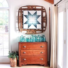 a wooden dresser sitting next to a window