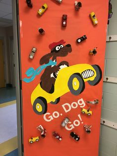 a door decorated with magnets that say go dog and car on it, surrounded by cars