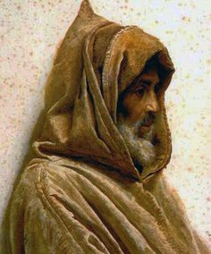 an old man with a beard wearing a brown robe and standing in front of a wall