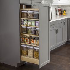 an organized pantry in the middle of a kitchen