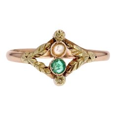 This is part of Chairish’s Fine Jewelry assortment.  Ring in 18 karat rose and green gold, eagle head hallmark.  A delightful antique You and Me ring in rose gold, with its closed-set top adorned with a fine half-pearl and a round emerald decorated on either side with a chased flower in green gold.  Green gold leaves decorate the central motif on either side to join the rose gold ring.  Height : 10.2 mm approximately, width : 13.5 mm approximately, thickness : 2,3 mm approximately, ring width at Green Gold Ring, Antique Emerald Ring, Medieval Rings, Vintage Cocktail Ring, Gold Eagle, Etsy Gold Ring, Eagle Head, Gold Leaves, Antique Engagement Rings