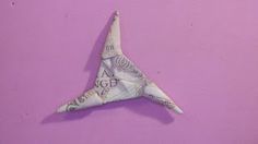 an origami bird made out of money on a purple background with the words i love you written in it