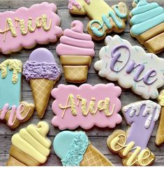 decorated cookies with ice cream, waffles, and other toppings on a wooden surface