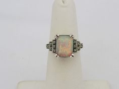 Vintage Sterling Silver White Opal Engagement Ring...Marked 925...Total of weights 3.1grams... Size 9...Measure of Face 11.5MM...It's in good condition. Classic Silver Opal Ring With Multi-stone, Vintage Silver Multi-stone Opal Ring, Silver Opal Ring For Collectors, Formal Silver Opal Ring With Center Stone, White Gold Opal Ring Stamped 925 For Formal Occasions, White Opal Engagement Ring, Opal Engagement Ring, Engagement Ring Size, Opal Engagement