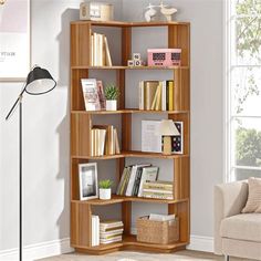 a living room with a couch, chair and bookshelf on the floor in front of a window