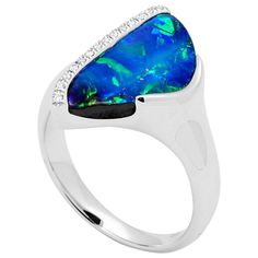 "Hyams" presents eye-catching Australian boulder opal, dressed in a thin line of sparkling diamonds, perfectly crafted in 18K white gold ring. 4.28ct natural gemstone comes from Winton, Queensland. Designed by Renata Bernard for your special occasions or just because. The gemstone at the centre of this opal ring is an Australian boulder opal from Winton in Queensland, Australia. Precious opals' distinctive quality is their "play of colour," a phenomenon that manifests in opal's colours shifting Boulder Opal Ring, Opal Diamond Ring, Contemporary Engagement Rings, Precious Opal, Australian Boulder Opal, Gold Cocktail Ring, Gold Cocktail, Diamond Cocktail Rings, 18k Gold Ring