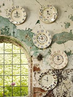 there are many clocks on the wall with holes in them and numbers painted on it