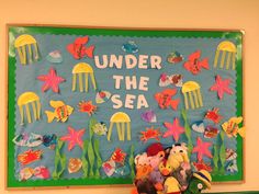 under the sea bulletin board with stuffed animals and fish on it's back wall