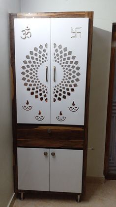 the cabinet is made out of wood and has an intricate design on it's doors