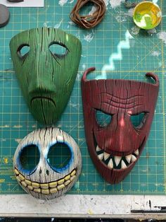 three masks are sitting on a cutting board