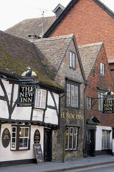 the new inn is located on the corner of an old town street in england, and it's only open for business