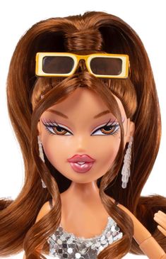 a close up of a barbie doll with sunglasses on it's head and long brown hair