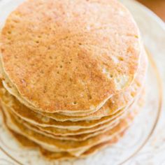 a stack of pancakes sitting on top of a glass plate