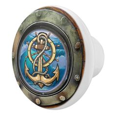 an anchor and rope on a ship's porthole door knob, painted with blue water