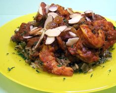 a yellow plate topped with rice and meat