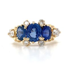 10K Yellow Gold Three Stone 2.5CT Oval Cut Blue Sapphire & 1/3CT Round White Diamond Ring 3.6 Grams Size 6  2.5CT Total Weight 3 Oval Cut Blue Sapphire Center Stones 1/3CT Total Weight 6 Round White Diamonds 2.7mm Band Width This stunning 10K Yellow Gold Ring features three captivating Oval Blue Sapphires totaling 2.5 carats,  beautifully flanked by sparkling Round Diamonds weighing 1/3 carats. The deep Blue Sapphires create  a striking contrast against the warm glow of the Yellow Gold band, making this ring an elegant and timeless  choice for any occasion.  If you have any questions or concerns, please do not hesitate to ask! Blue Oval Cluster Ring With Accent Stones, Blue Oval Multi-stone Cluster Ring, Blue Oval Cluster Ring Fine Jewelry, Blue Oval Cluster Ring In Fine Jewelry Style, Oval Blue Sapphire Ring With Diamond Accents, Oval Blue Cluster Ring With Brilliant Cut, Classic Blue Multi-stone Cluster Ring, Sapphire Multi-stone Oval Diamond Ring, Oval Blue Multi-stone Sapphire Ring