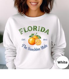 🍊Retro Florida crewneck sweatshirt!🍊 This trendy sweater is super soft and comfortable and perfect as an oversized beach cover up or for a casual day out. Looks super cute with jeans or shorts. Makes a nice gift for Mother's Day, a Birthday or a Florida lover! 🌴 Comes in 8 pretty colors. ✨PRINT: This is a handmade, Direct-to-Garment printed item. The designs are professionally printed directly on to the shirt. All over printing is used. The ink is printed directly into the fabric. ✦Images may sometimes appear larger in the photo than in person due to images being a close up on the screen so you can view them easier. ✦Depending on what device you are using to view the listings, the colors may vary slightly. -------------------------------------------------- ✨YOUR GILDAN 18000 SWEATSHIRT: Spring Vacation Crew Neck Sweatshirt, Fall Vacation Long Sleeve Sweatshirt, Sweatshirt Aesthetic, Beach Lover Gifts, Trendy Sweaters, Vintage Florida, Sunshine State, Pretty Colours, Summer Beach