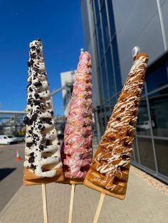 three different types of donuts on sticks