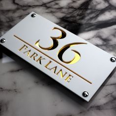 a close up of a number plate on a marble surface