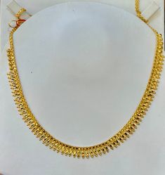 Indian designer choker necklace , 916 Yellow Gold GOLD PURITY : pure 22k / 916 gold purity Appx Weight: 13.90 grams Length : adjustable upto 16.5 inches Length Colour : YELLOW GOLD Hallmark: Hallmarked 916 stamp Hook: '' fish hook Design :Beautiful choker Bombay necklace indian style pendant necklace set. Design will be similar to listings designs pictures depending on stocks availability. Authentic 916 Gold FAQs Q: Is it real gold? A: yes it's real authentic genuine 916 gold Q: can pawn? A: yes Real Gold Necklace Indian, 13 Grams Gold Necklace, Molathadu Designs Gold, 12 Grams Gold Necklace, 16 Grams Gold Necklace Designs, 5 Grams Gold Necklace, Gold Choker Necklace Indian, Simple Gold Necklace Designs, Light Weight Gold Necklace