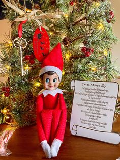 an elf is sitting in front of a christmas tree with a poem written on it