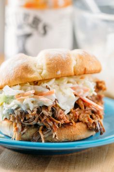 a pulled pork sandwich on a blue plate