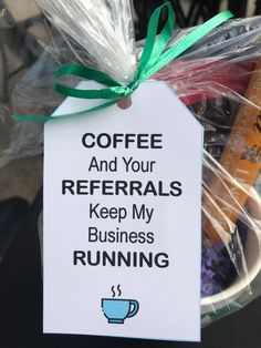 coffee and your referals keep my business running sign hanging from a basket filled with coffee beans